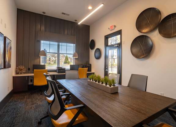 A conference room with a long table and chairs.