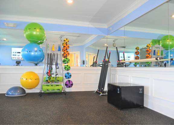 A room with exercise equipment and a mirror.