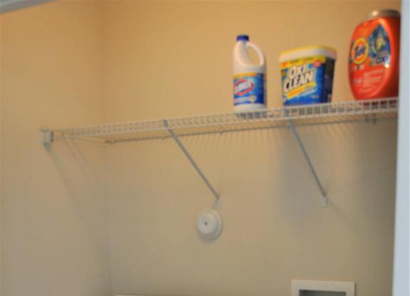 A small laundry room with a washer and dryer.
