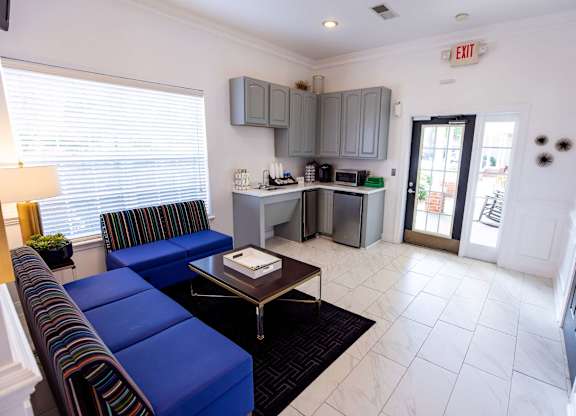 A living room with a blue couch and a coffee table.