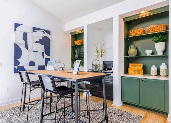 A dining room with a table and chairs.