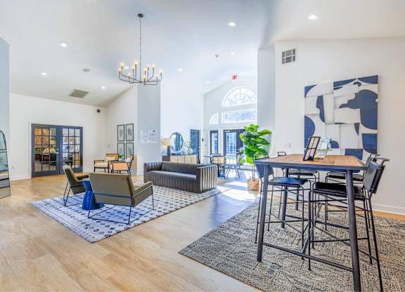 A modern living room with a blue and white rug on the floor.