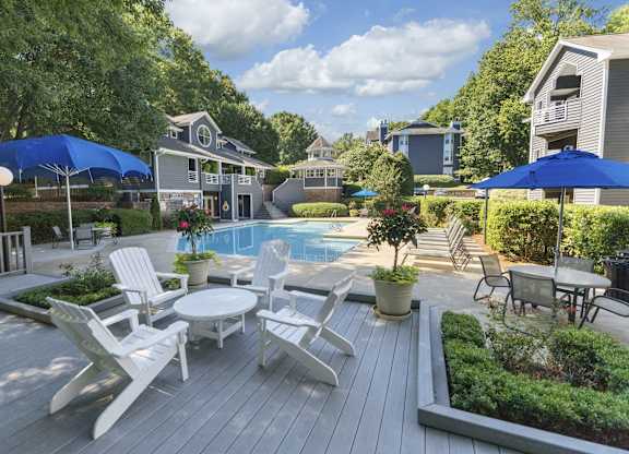 A backyard with a pool and deck.