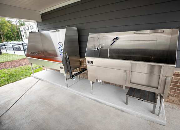 A stainless steel outdoor kitchen with a grill and sink.