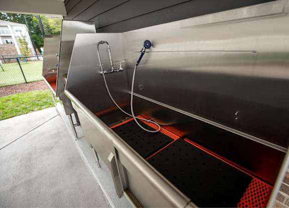 A stainless steel oven with a red interior.