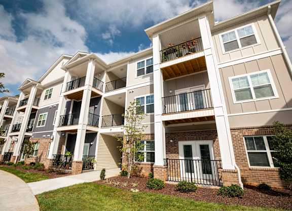 Apartment building with balconies and a clear sky.