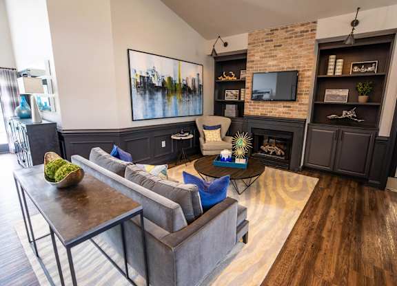 A living room with a grey couch and a wooden coffee table.