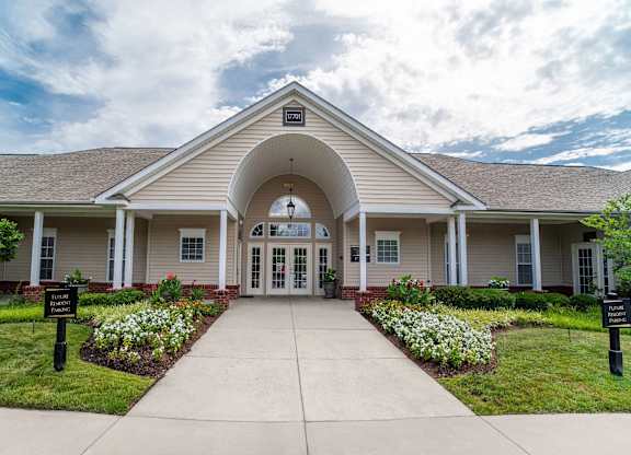 A building with a covered walkway leading to the front door.
