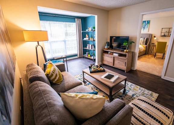 A living room with a grey couch and a coffee table.
