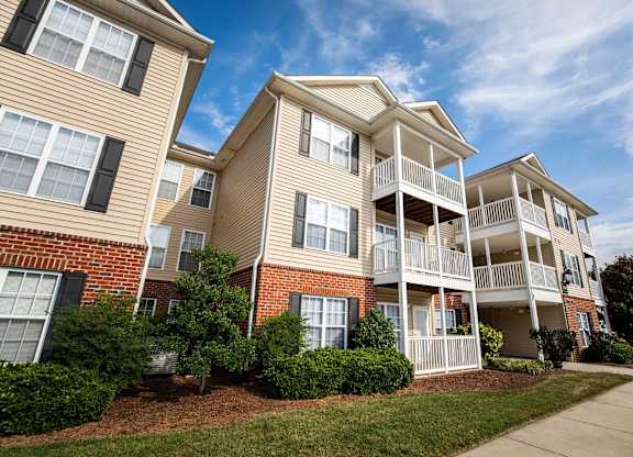 Apartment building with balconies and windows.