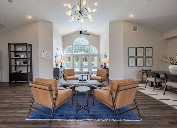A living room with a large table and chairs.