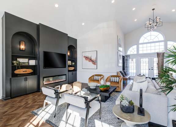 A modern living room with a fireplace and a large window.