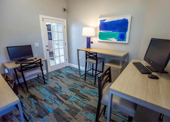A room with two desks and two chairs.
