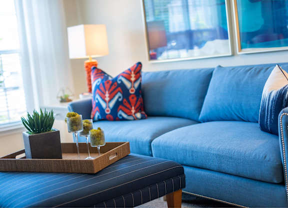 A blue couch with a tray on top of it.
