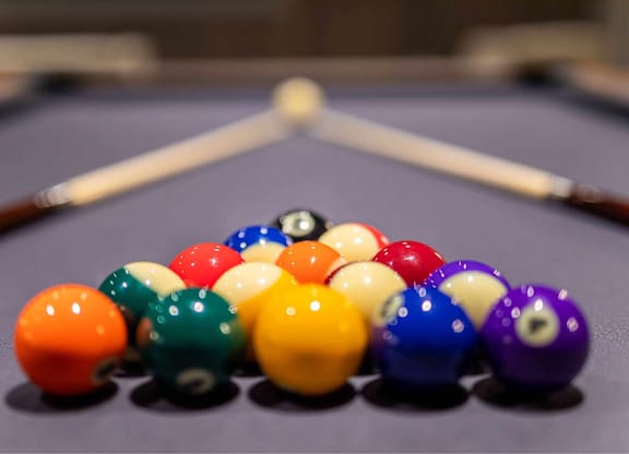 A pool table with a variety of colored balls.