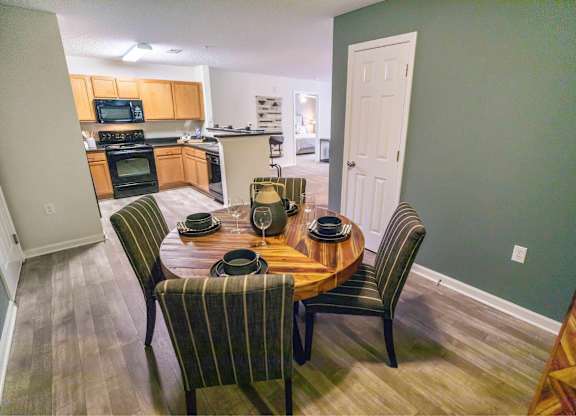 A dining room with a table set for four.