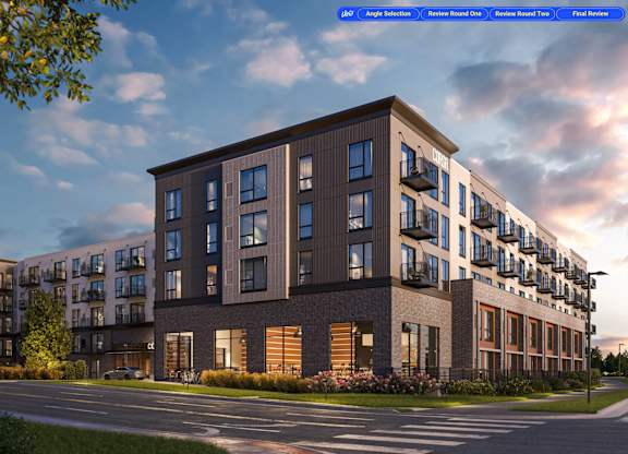 A modern apartment building with a parking lot in front.