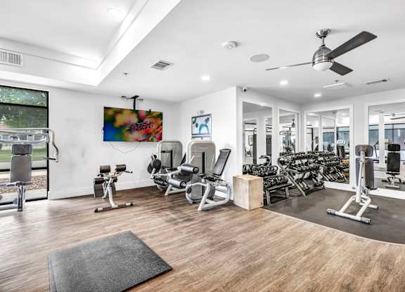 A spacious gym with a mirrored wall at Markethaus 3700 in Plano Texas