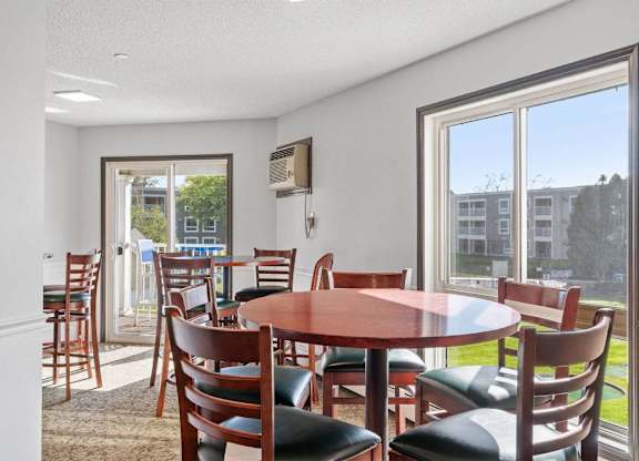 A dining room with a round table and chairs.