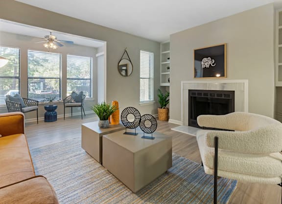 A living room with a fireplace and a chair.