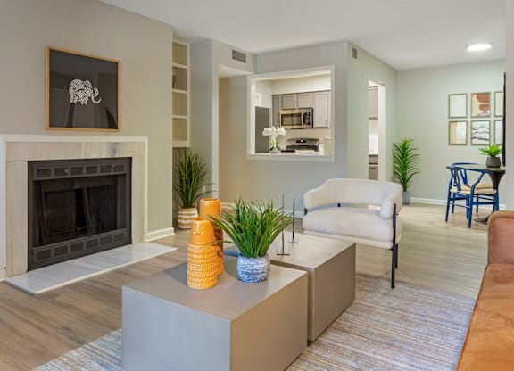 A living room with a fireplace and a grey sofa.