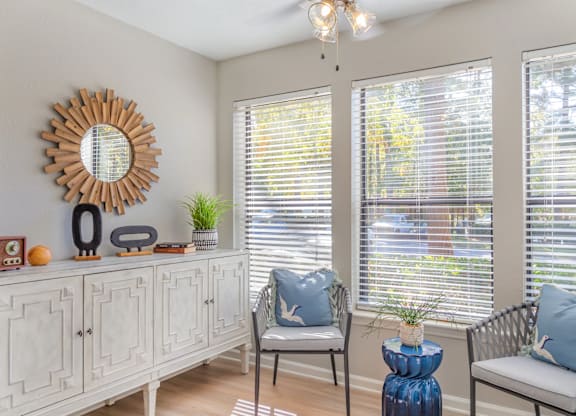 A sunny room with a chair and a table.