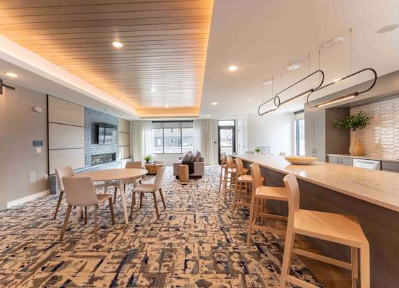 A modern dining area with a long table and chairs.