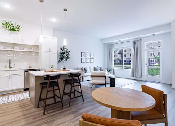 A modern kitchen with a dining table and chairs.