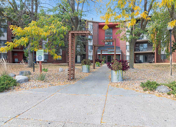 A brick archway leads to a building entrance.