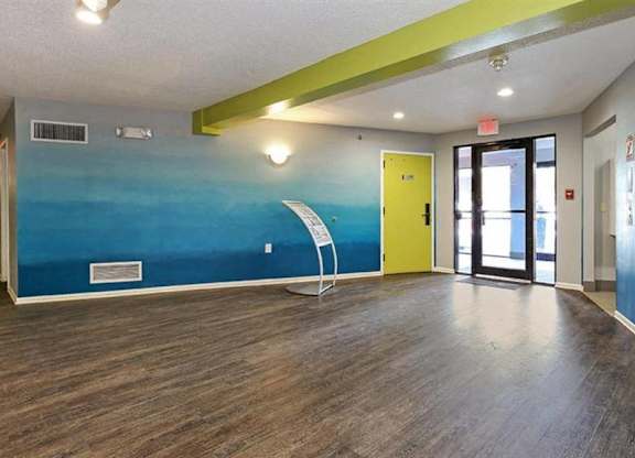 A room with a blue wall and a yellow door.