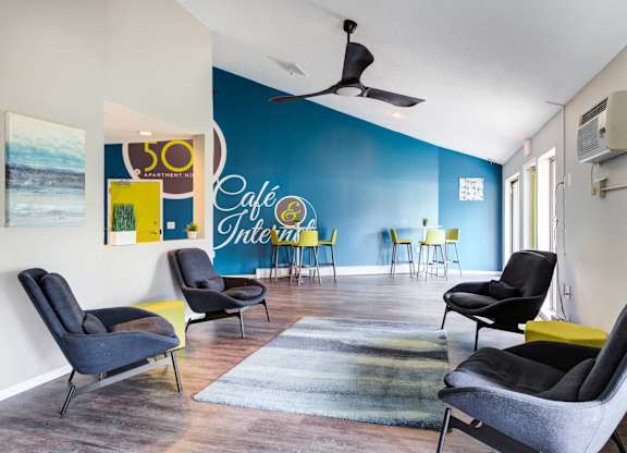 A room with a blue wall and a sign that says "Cafe Internet".