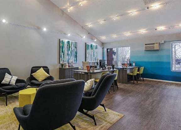 A living room with a yellow rug and a blue wall.
