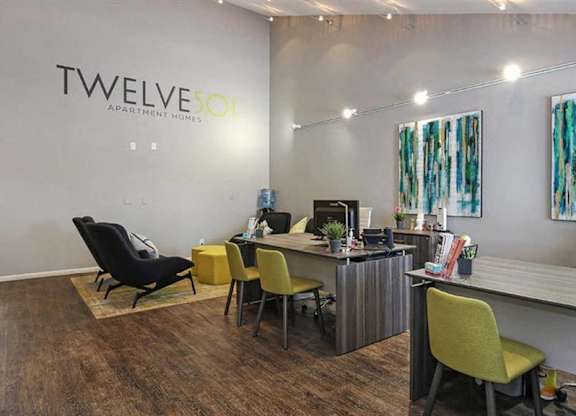 A room with a desk and chairs with the word twelve on the wall.
