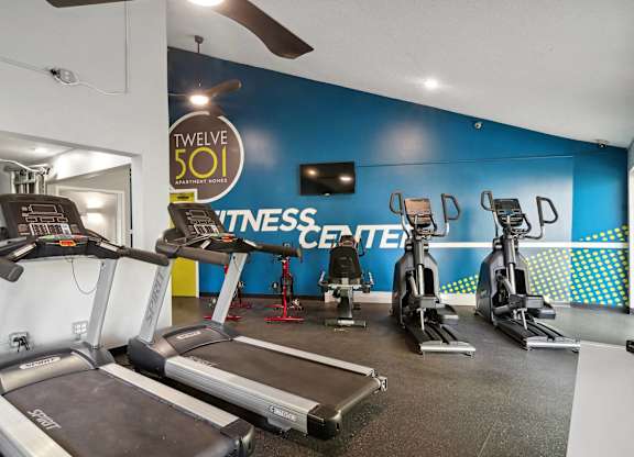A fitness center with treadmills and exercise bikes.