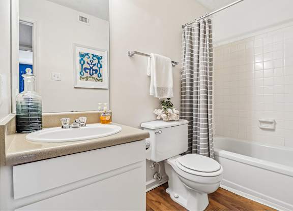 A white toilet sits next to a sink in a bathroom.