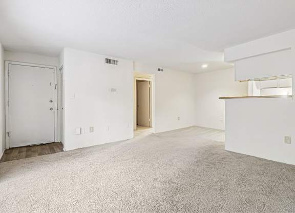 A large, empty room with a door and a window.