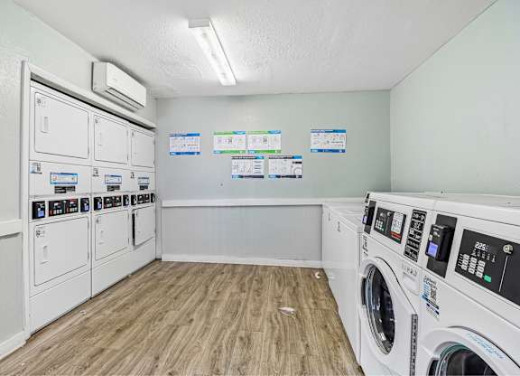 A laundry room with washers and dryers.