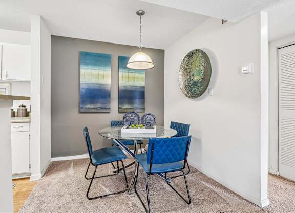 A dining room with a table set for two.