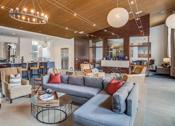 Community lounge with comfortable seating at Twin Creeks Crossing in Allen, TX