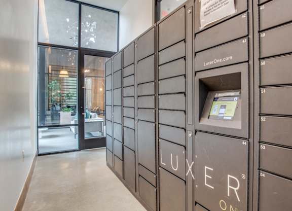 A row of Luxeer One mailboxes are lined up on a wall at Twin Creeks Crossing