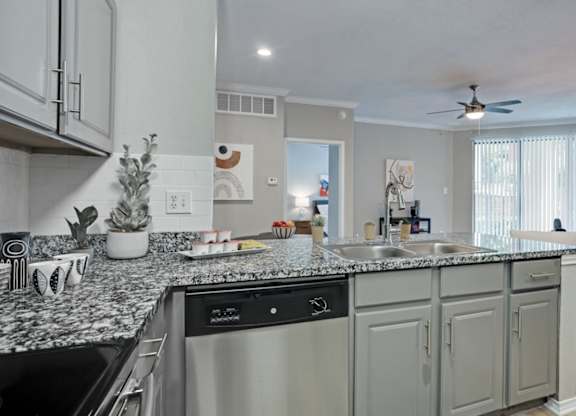 Kitchen with shaker-style cabinets at The Lana, apartments in Dallas, TX
