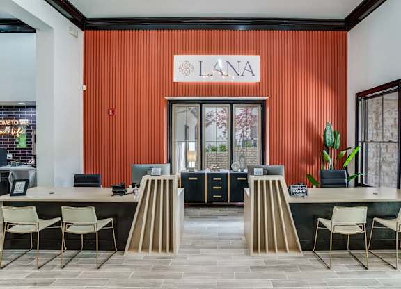 Reception area with a red wall at The Lana Apartments