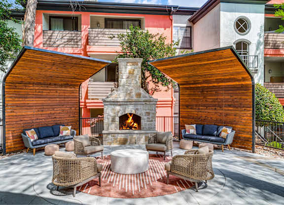 Outdoor patio with fireplace and seating at The Lana