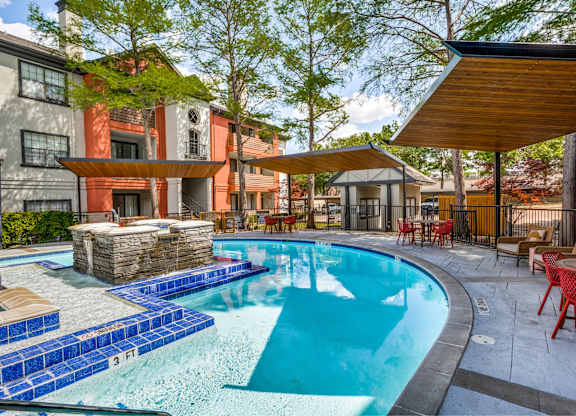 Swimming pool with poolside seating at The Lana, apartments in Dallas