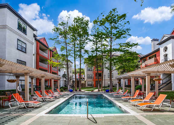 Swimming pool with poolside seating at The Lana, Dallas apartments