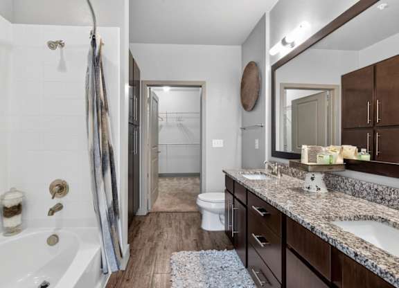 Bathroom with dual vanity at The Carson at Twin Creeks, apartments in Allen