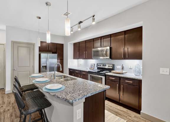 Kitchen with granite countertops at The Carson at Twin Creeks, Allen apartments for rent