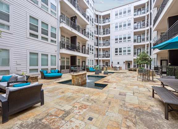 A courtyard with a pool and seating area.
