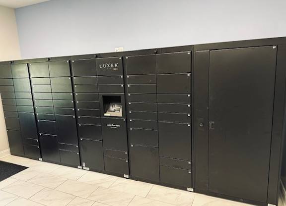 A row of black lockers with the word "LUXER" on the top.