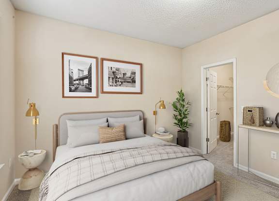 A bedroom with a bed, nightstand, and a lamp.